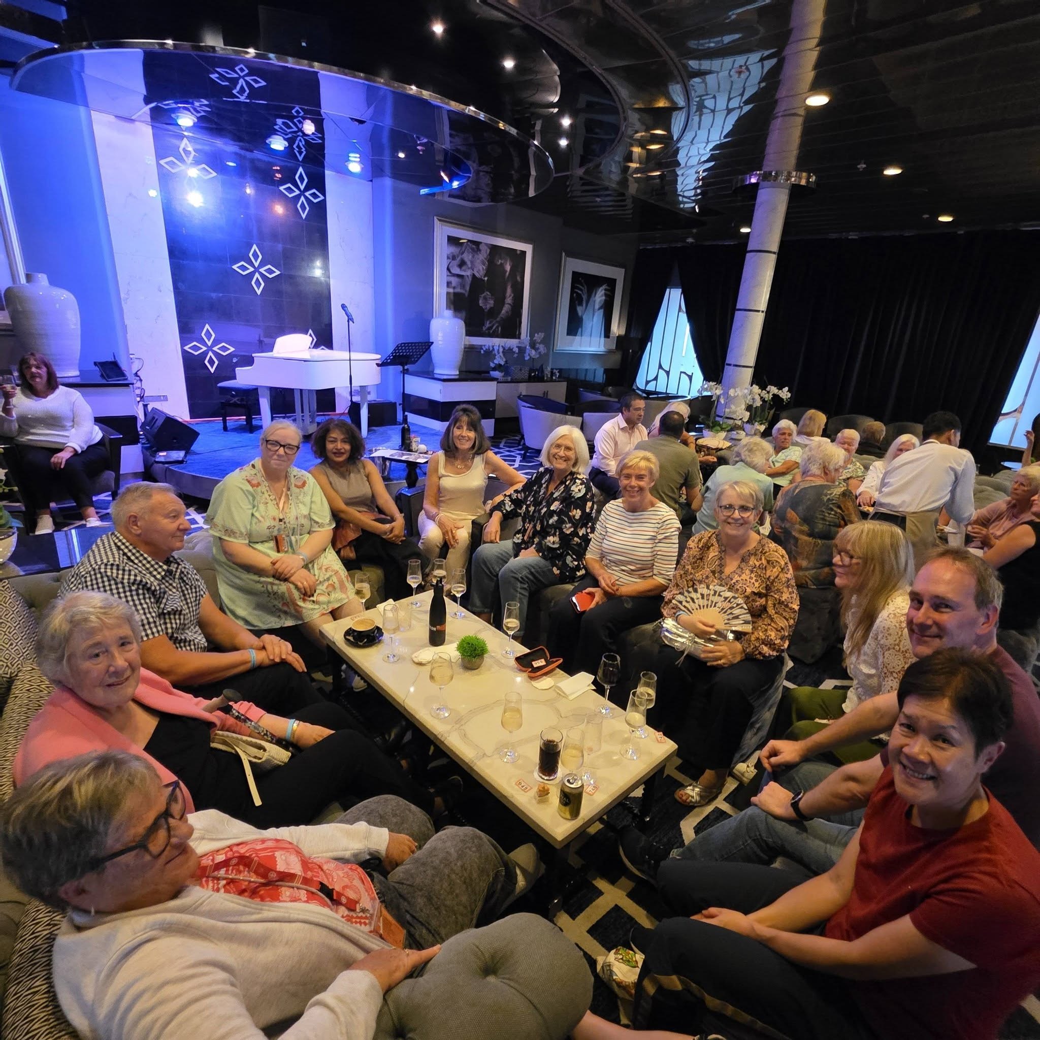 Solo cruise travellers gathered around a table onboard Ambience
