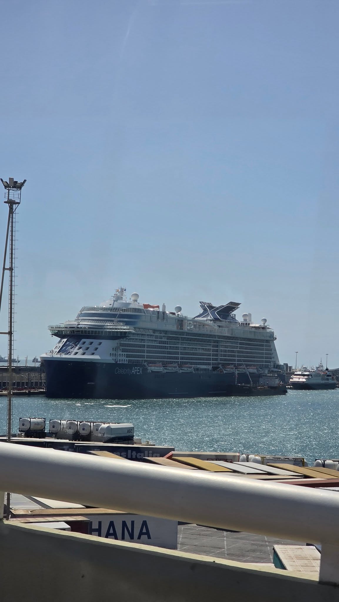 Celebrity Apex moored in Barcelona beneath a blue sky
