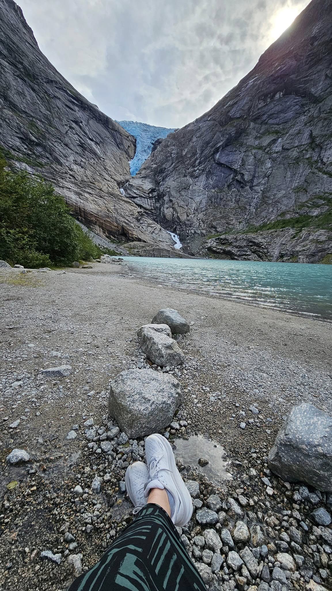 Briksdal Glacier and its turquoise lake, with my feet in the foreground