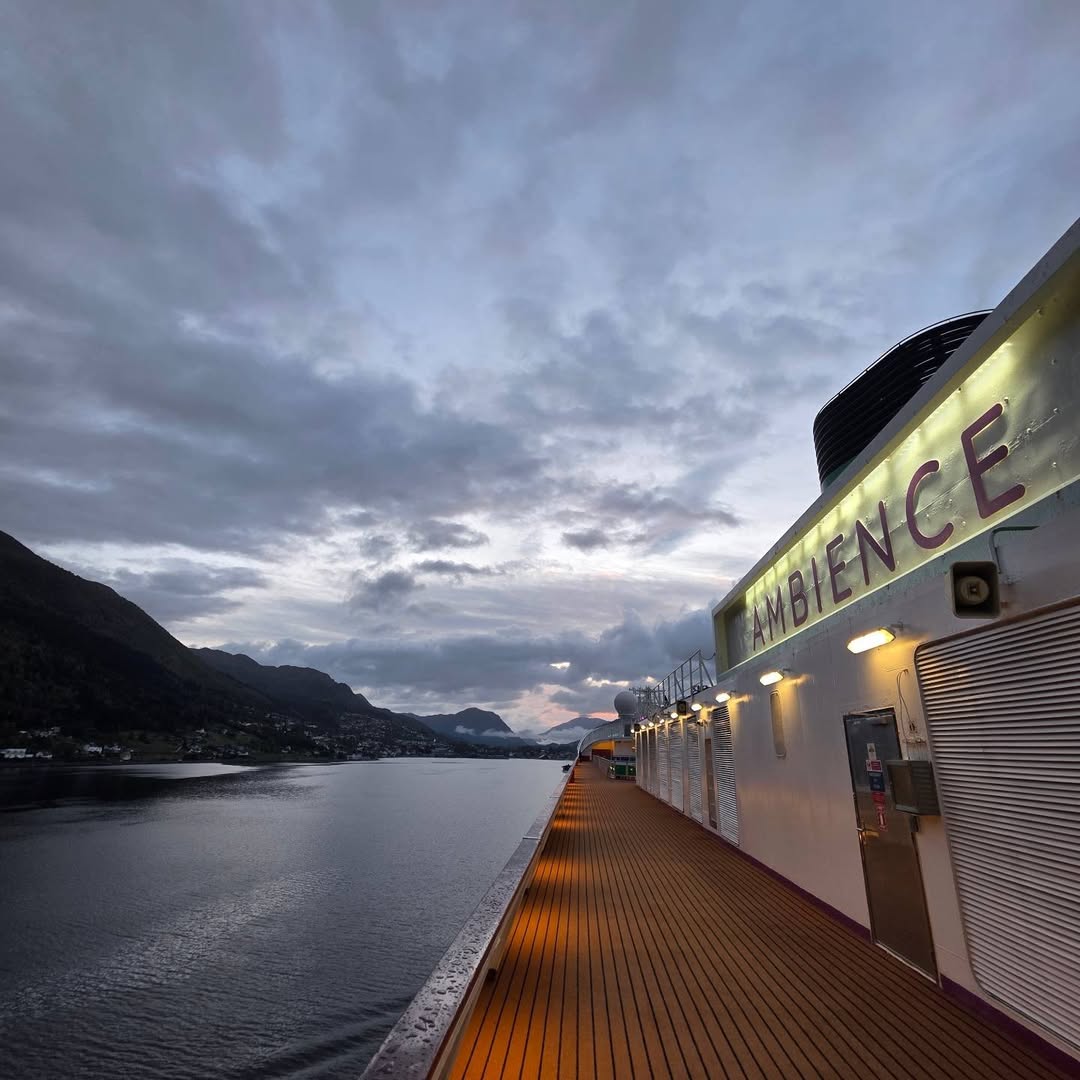 Lit Ambassador Ambience deck running beside the fjord at dawn.