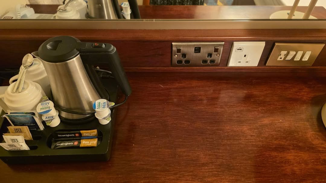 Cabin desk with kettle, tea/coffee set and power outlets.